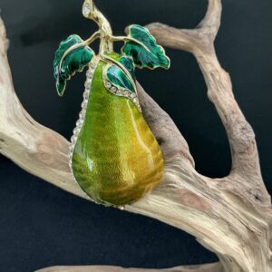 Edgar Berebi Pear Brooch perched on a branch with black background
