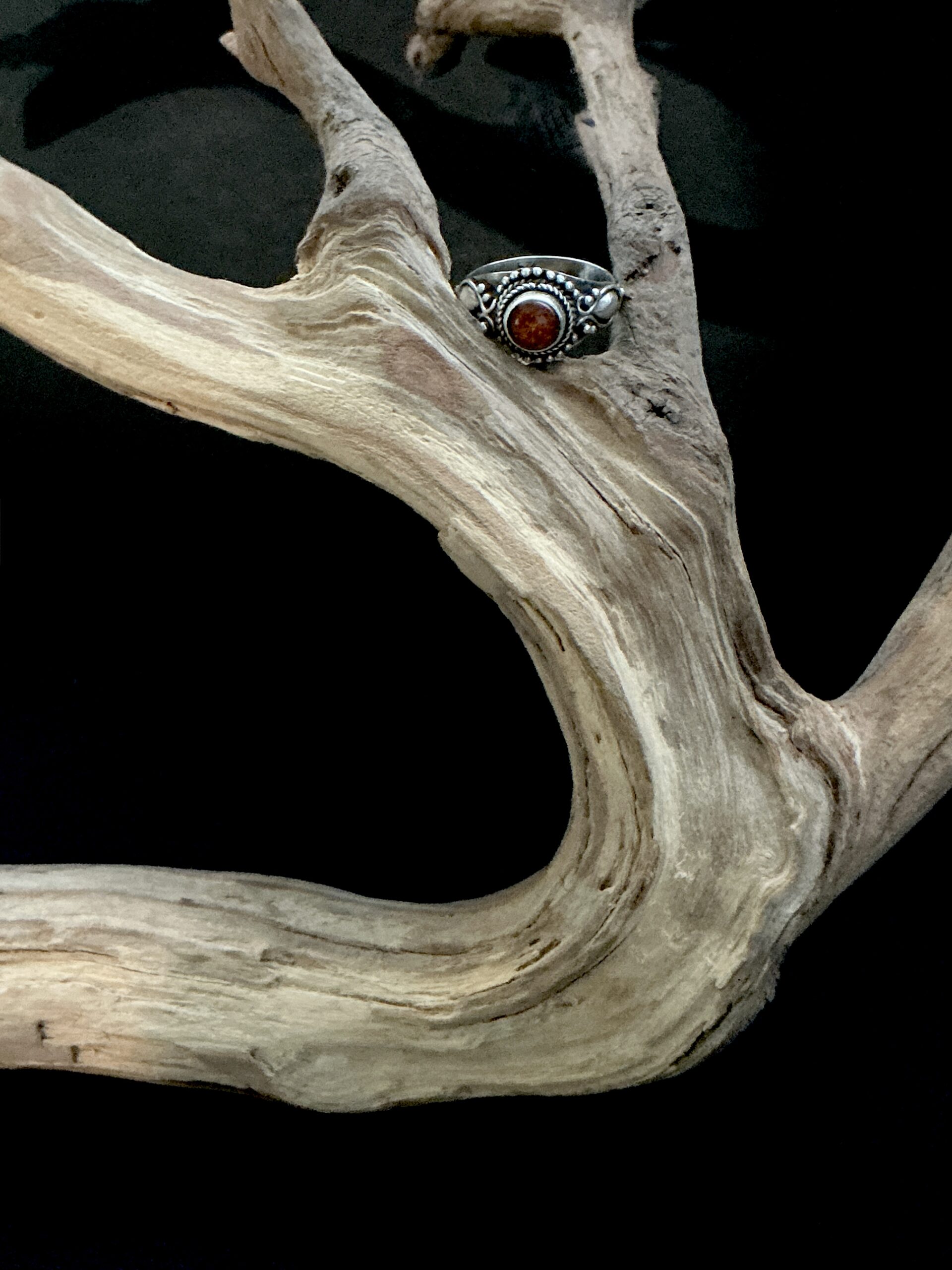 Rustic silver ring with round center amber on weathered driftwood