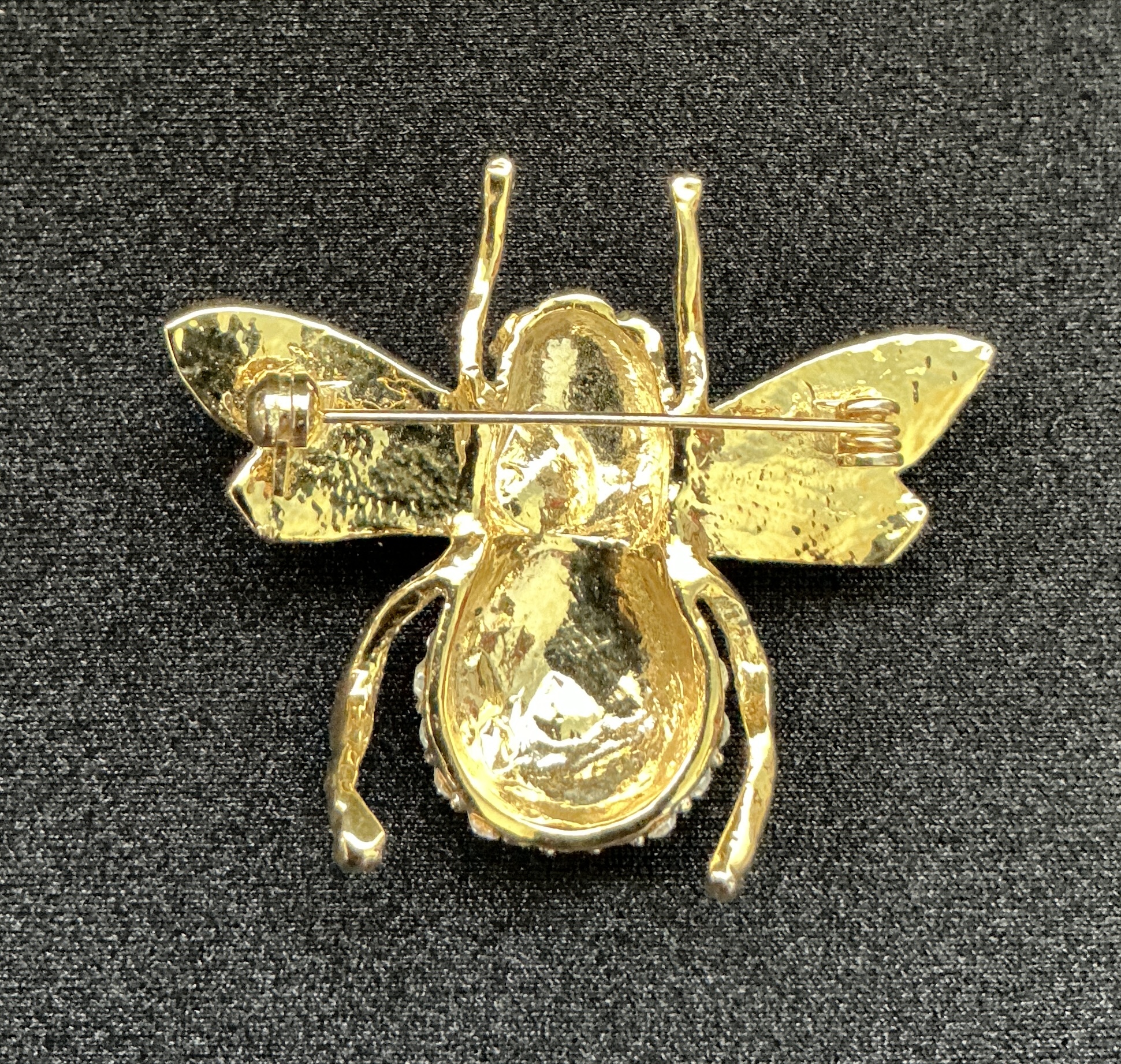 Gold bee brooch with wings and antennae, back view with pin closure