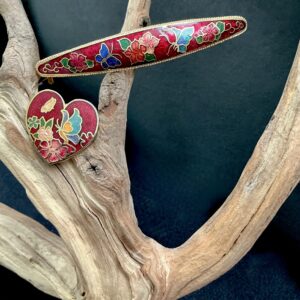 Red cloisonné barrette and heart pendant with floral and butterfly designs on driftwood