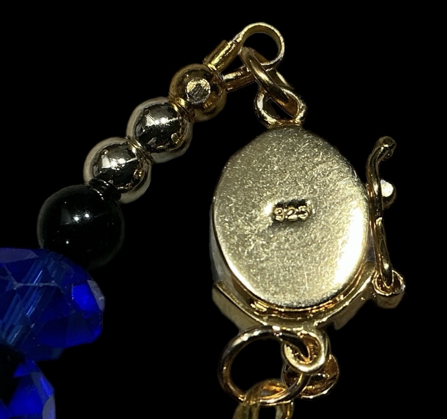 Gold clasp of articulated cloisonné fish necklace with "925" stamp.